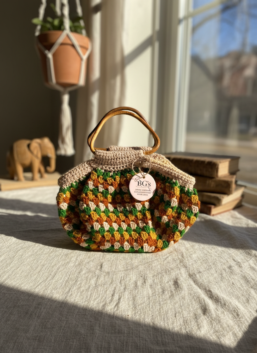 Crocheted handbag with wooden handle on a surface with books and a plant in the background