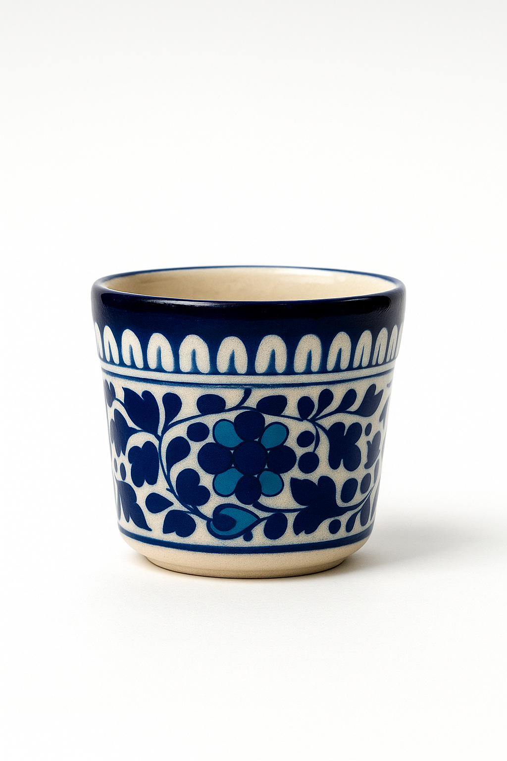 Ceramic cup with blue floral pattern on a white background