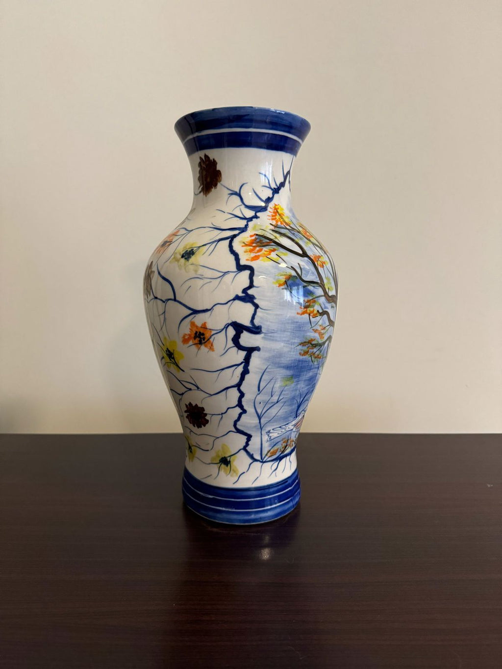 Decorative ceramic vase with floral patterns on a plain background